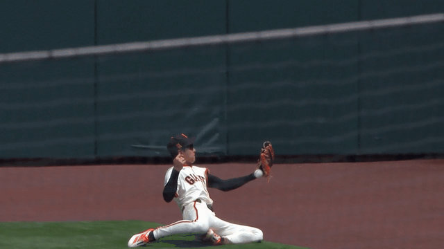 An animated gif of Jung Hoo Lee making a catch by securing the ball between his knees