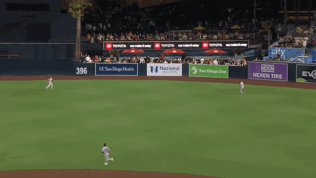 An animated gif of Alek Thomas making a sliding catch on the warning track