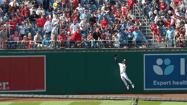 Jesse Winker makes a leaping catch at the wall