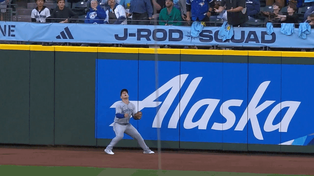 An animated gif of Daulton Varsho leaping to rob a home run
