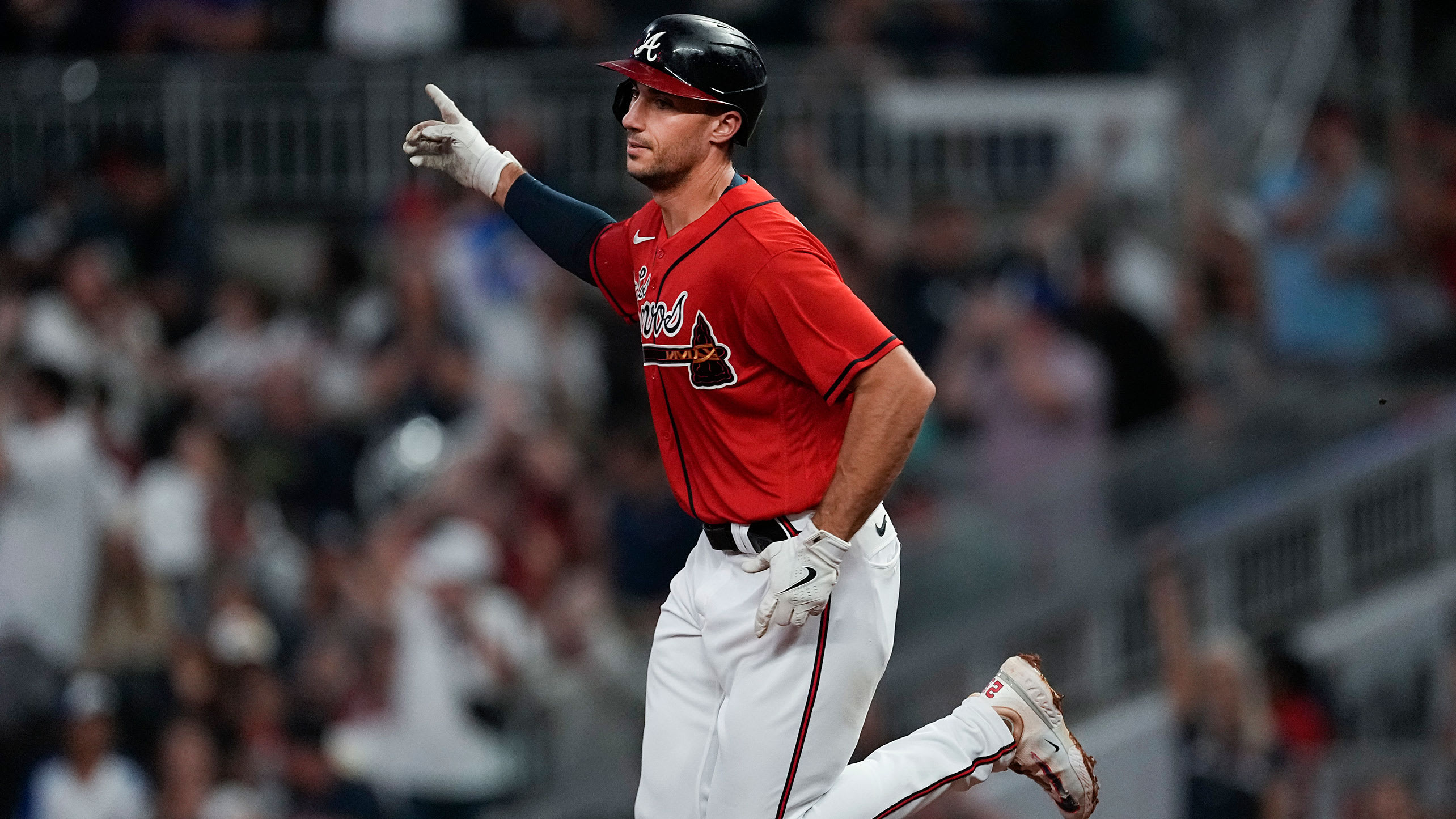 Matt Olson raises his arm as he trots around the bases