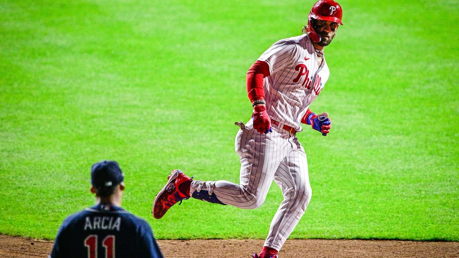 Bryce Harper stares at Orlando Arcia as he rounds second after a home run