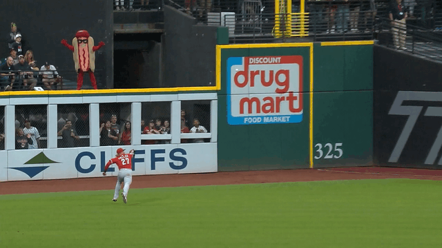 An animated gif of Reds right fielder Jake Fraley making a diving catch