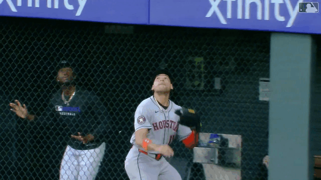 An animated gif of Cam Smith making a leaping catch and slamming into the right-field fence