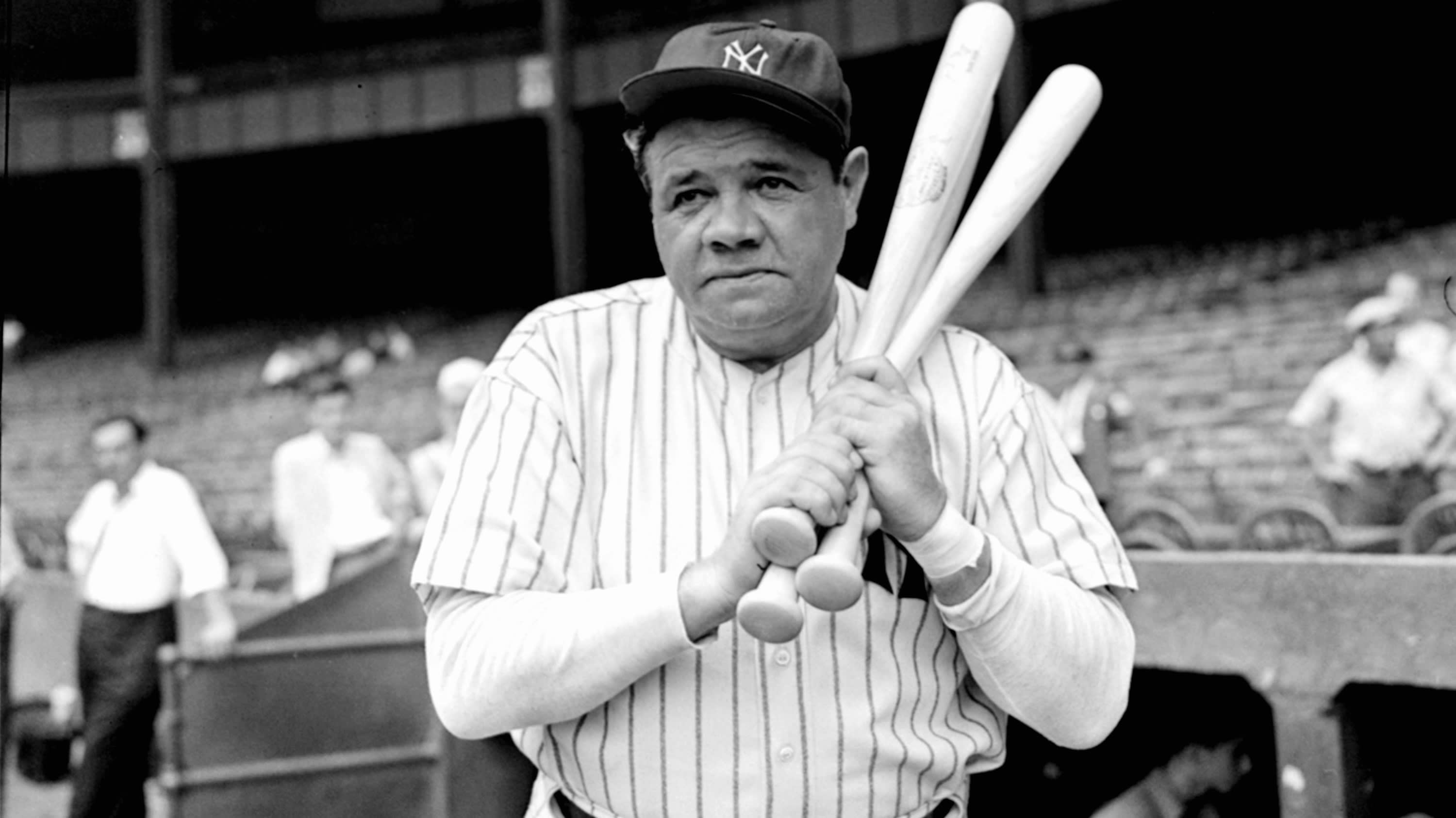 Babe Ruth holds three bats