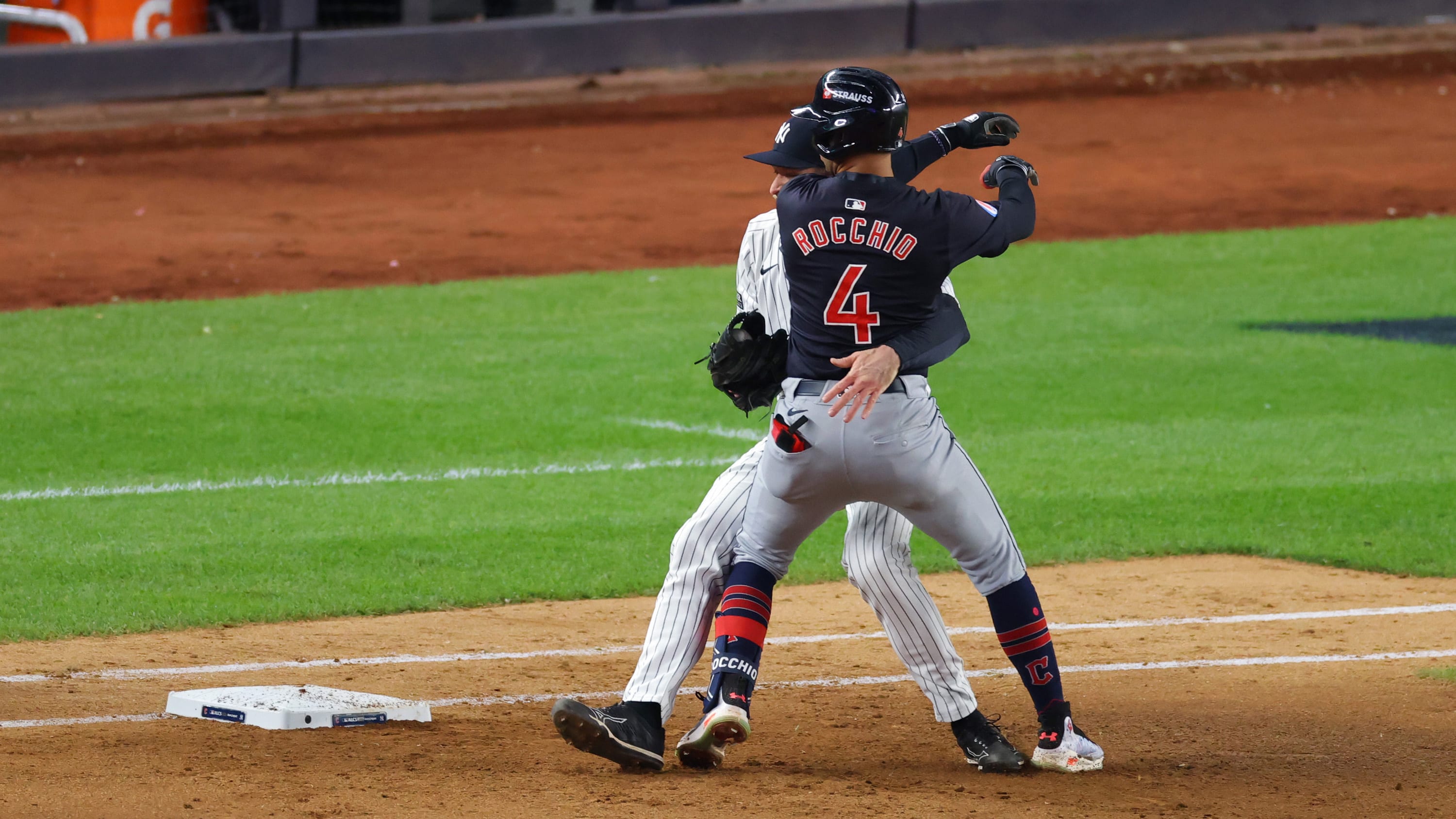Brayan Rocchio runs into Yankees pitcher Tim Hill on the basepaths