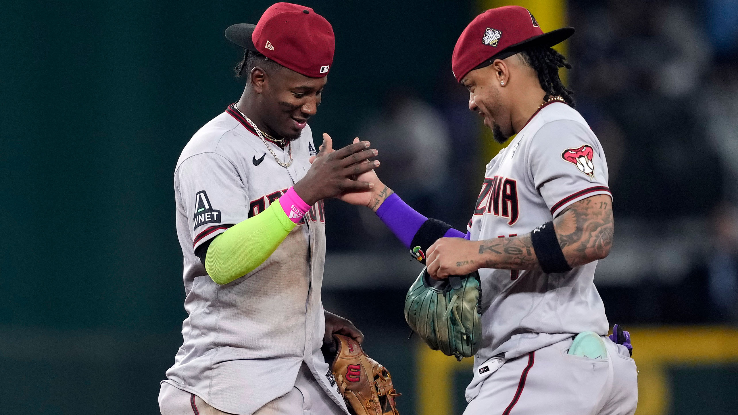 Geraldo Perdomo and Ketel Marte celebrate after Game 2