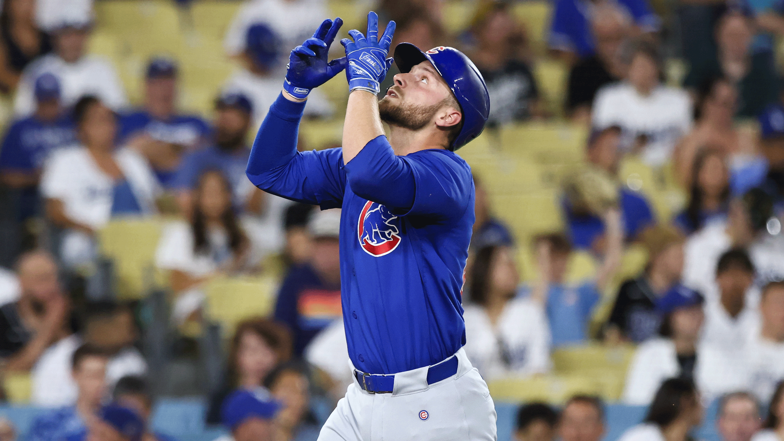 The Cubs' Michael Busch celebrates a home run just before touching the plate