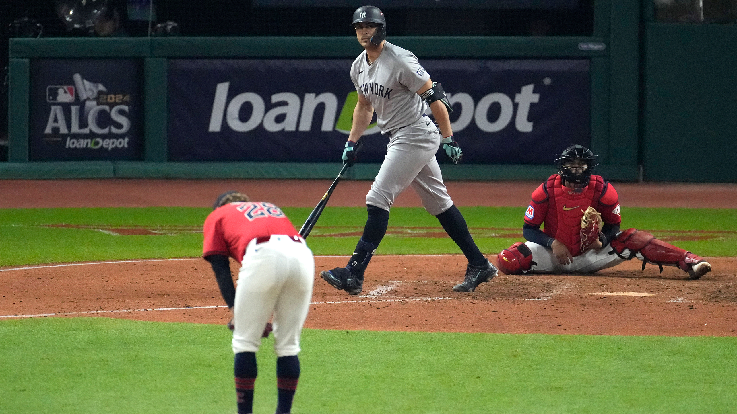 Guardians pitcher Tanner Bibee slumps over as Giancarlo Stanton watches his homer