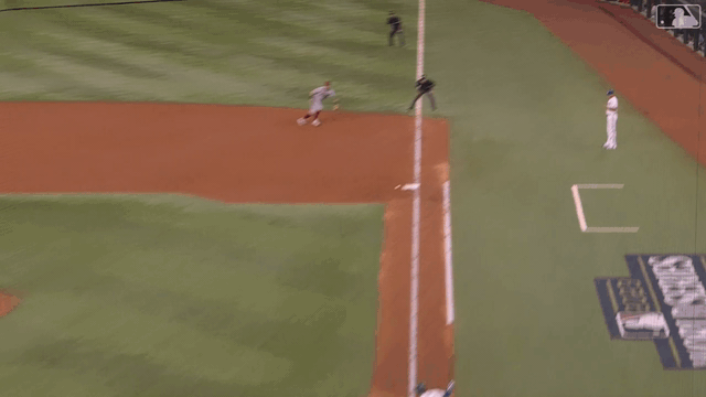 Christian Walker barehands a ball after it bounces off the first-base bag