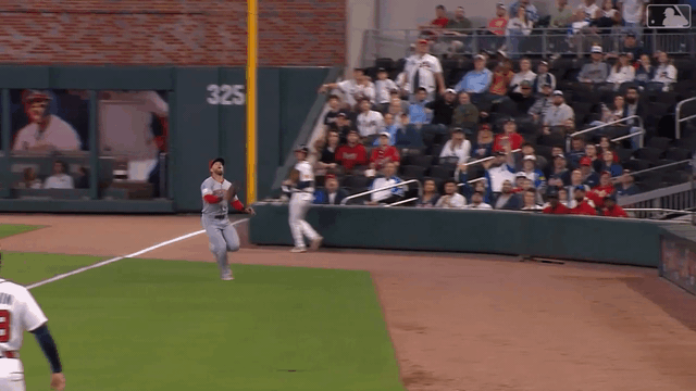 An animated gif of Jake Fraley making a diving catch