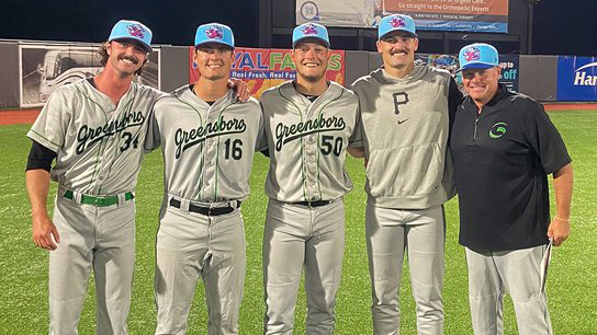 Greensboro's Michael Walsh, Jake Shirk, catcher Derek Berg, Khristian Curtis and pitching coach Matt Myers