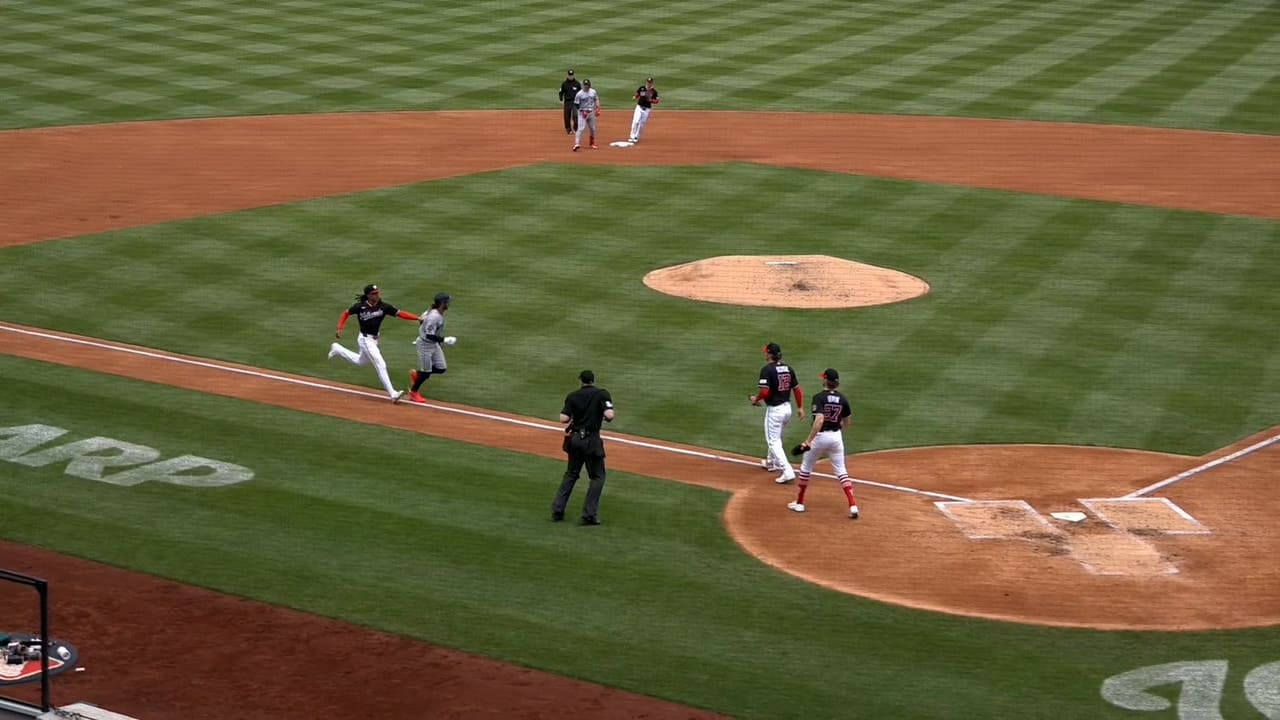 A horde of Nationals run down Austin Martin at home plate