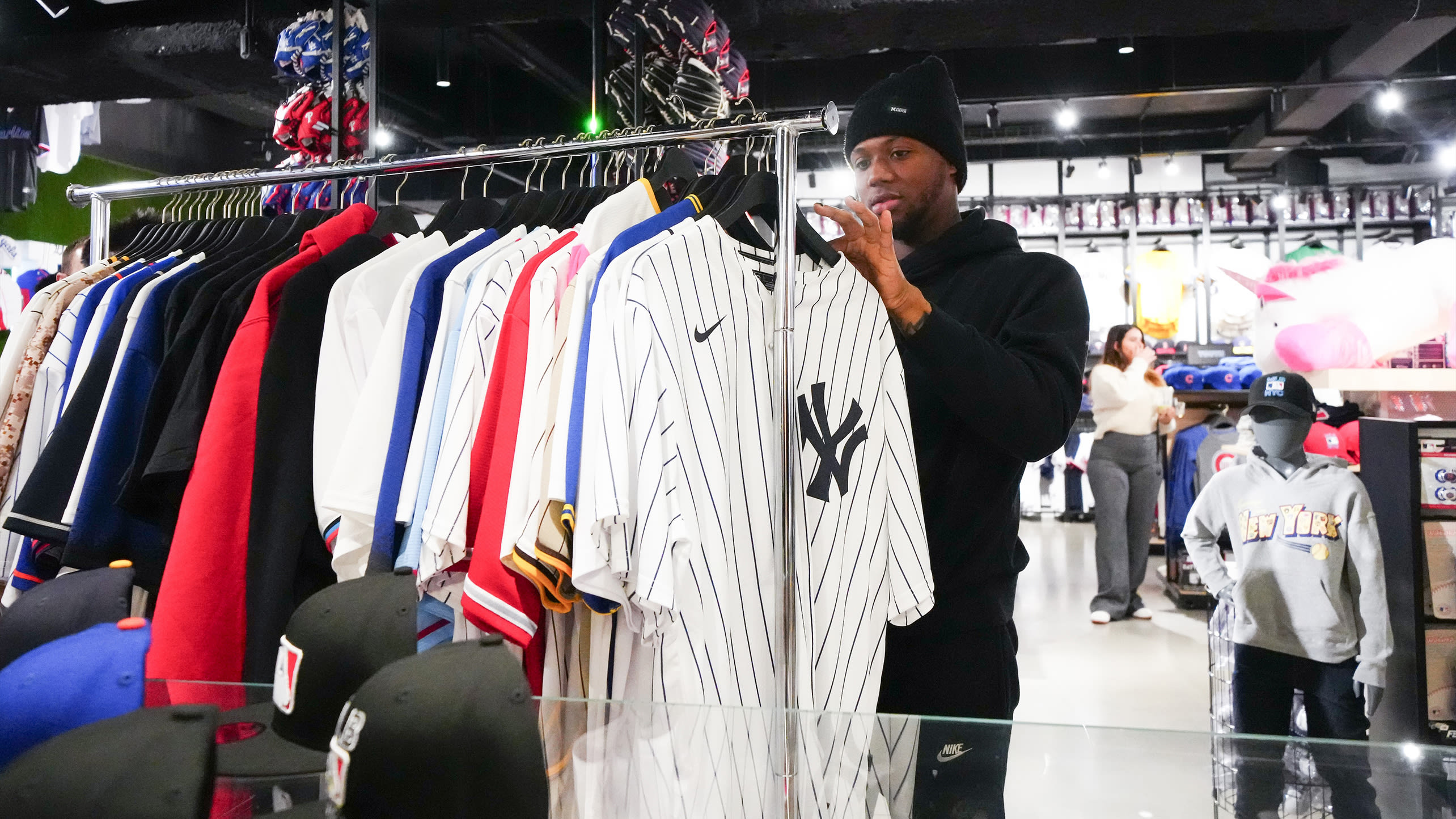 Ronald Acuña Jr. looks through a rack of jerseys