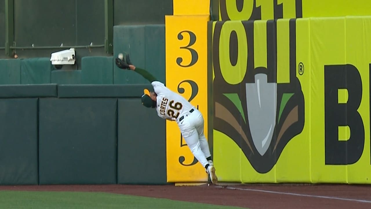 A's right fielder Carlos Cortes makes a twisting catch