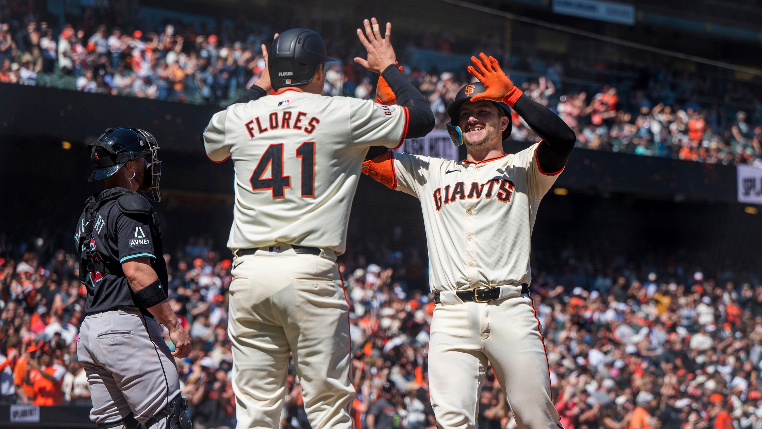 Wilmer Flores and Patrick Bailey high-five at home plate