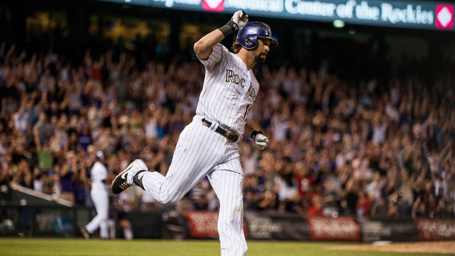 Todd Helton rounds first after hitting a home run