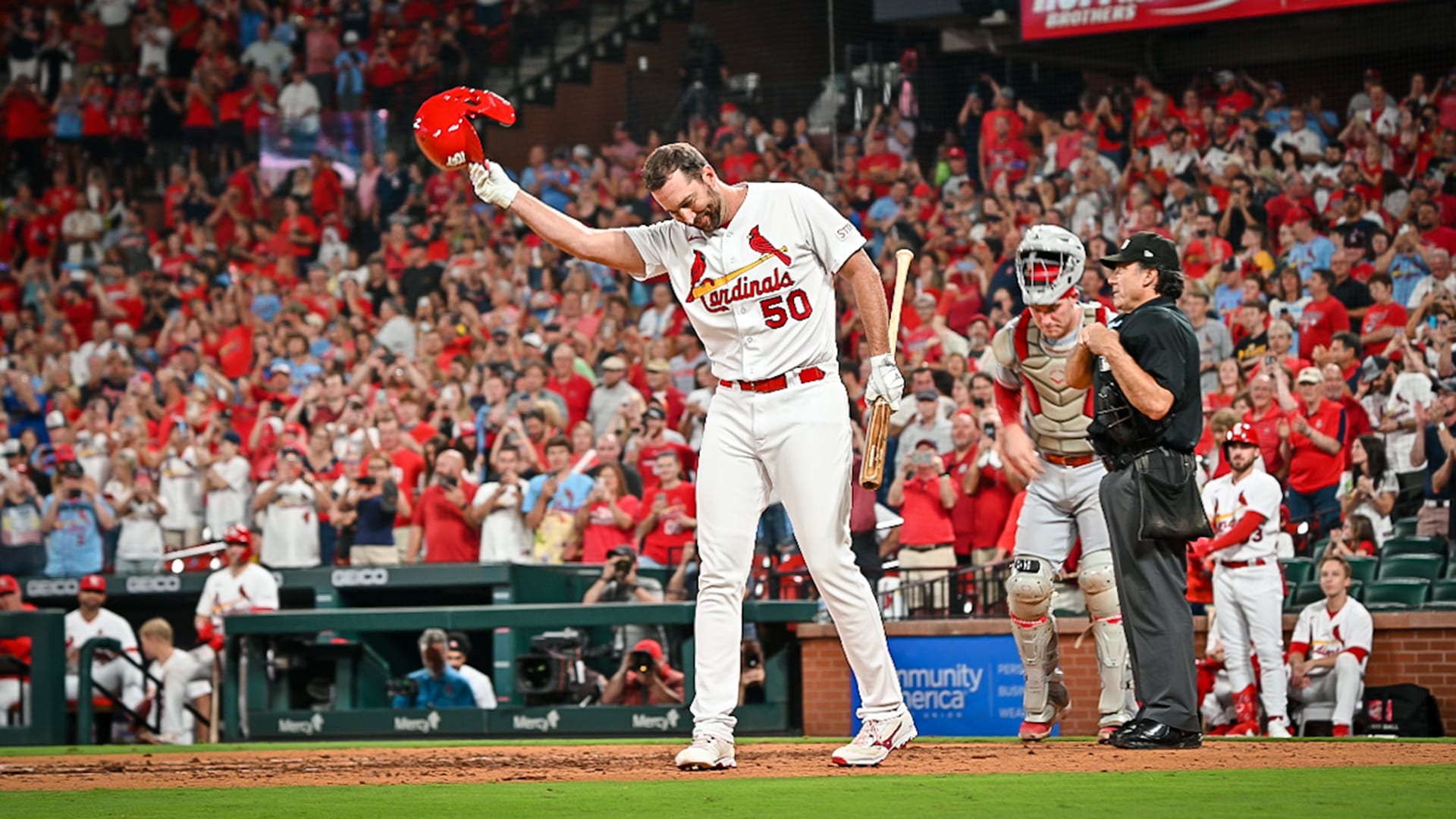 Adam Wainwright doffs his helmet as he steps up to the plate