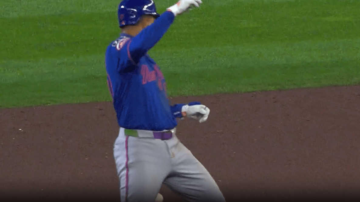 A screenshot of the Mets' Mark Vientos reacting as he's hit in the backside by a thrown baseball