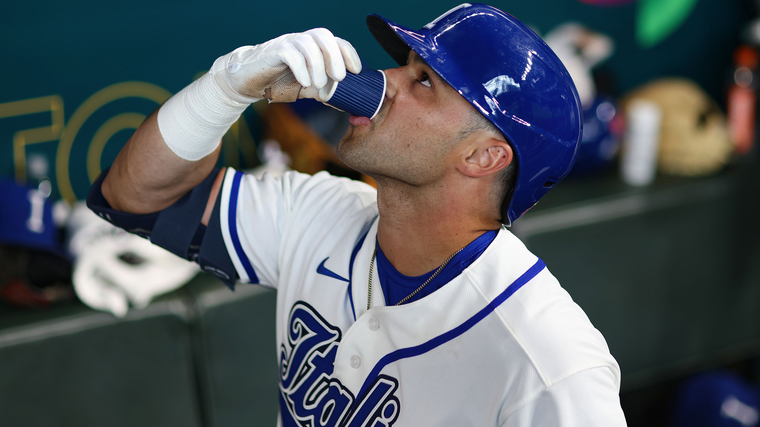 Dante Nori drinks a shot of coffee in the dugout