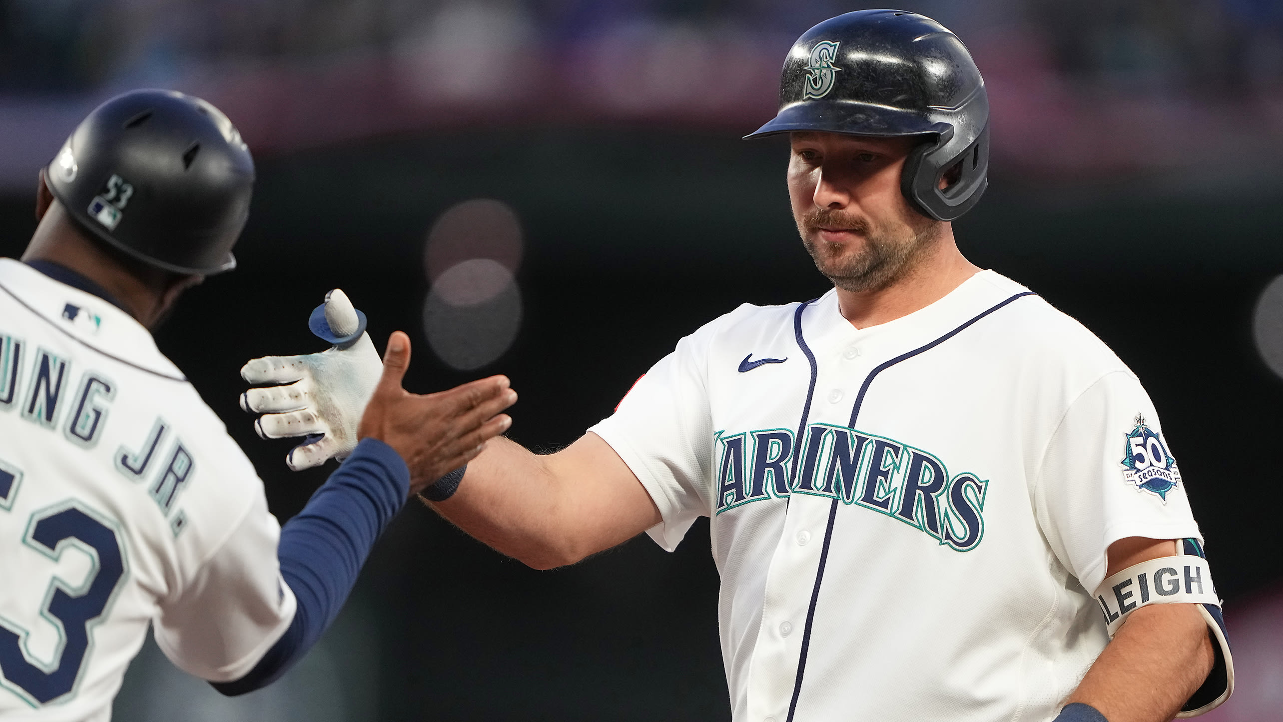 Cal Raleigh is greeted at first base