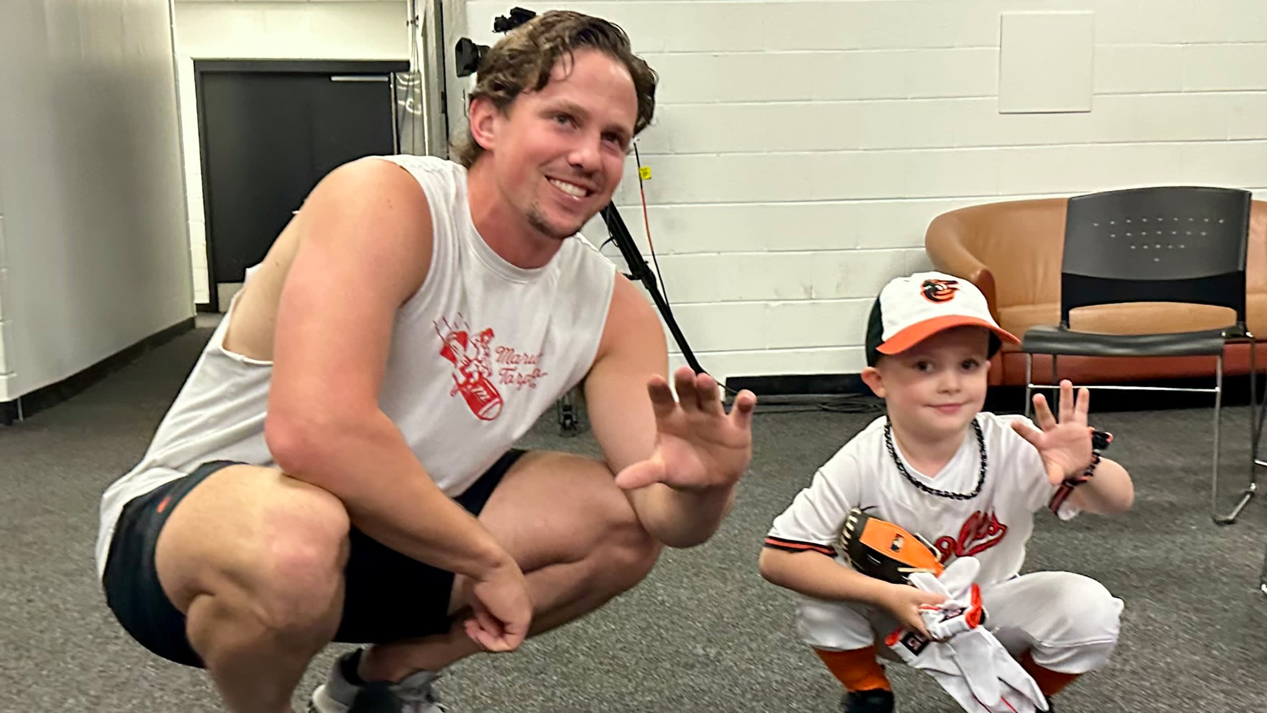 Adley Rutschman poses for a photo with a young fan