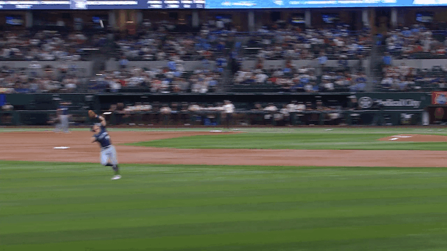 An animated gif of Mariners third baseman Ben Williamson making a twisting, leaping catch of a pop fly in short left field and falling to the ground