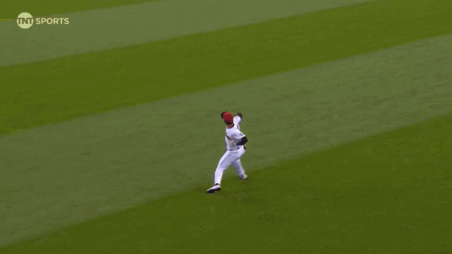 An animated gif of Steven Kwan throwing out a runner at home plate