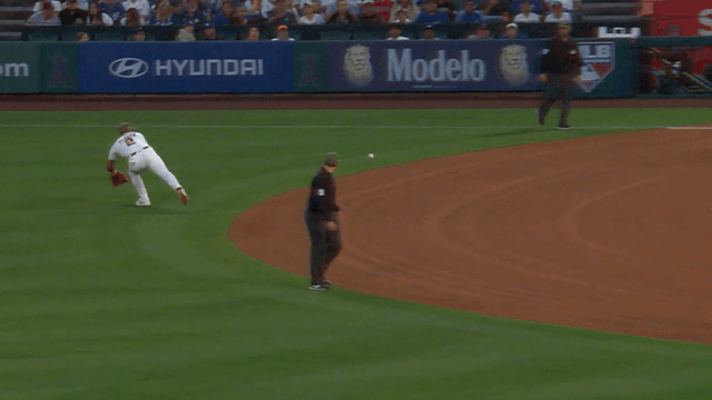 An animated gif of Oswald Peraza making a diving stop and rolling over to throw off one knee while falling backwards