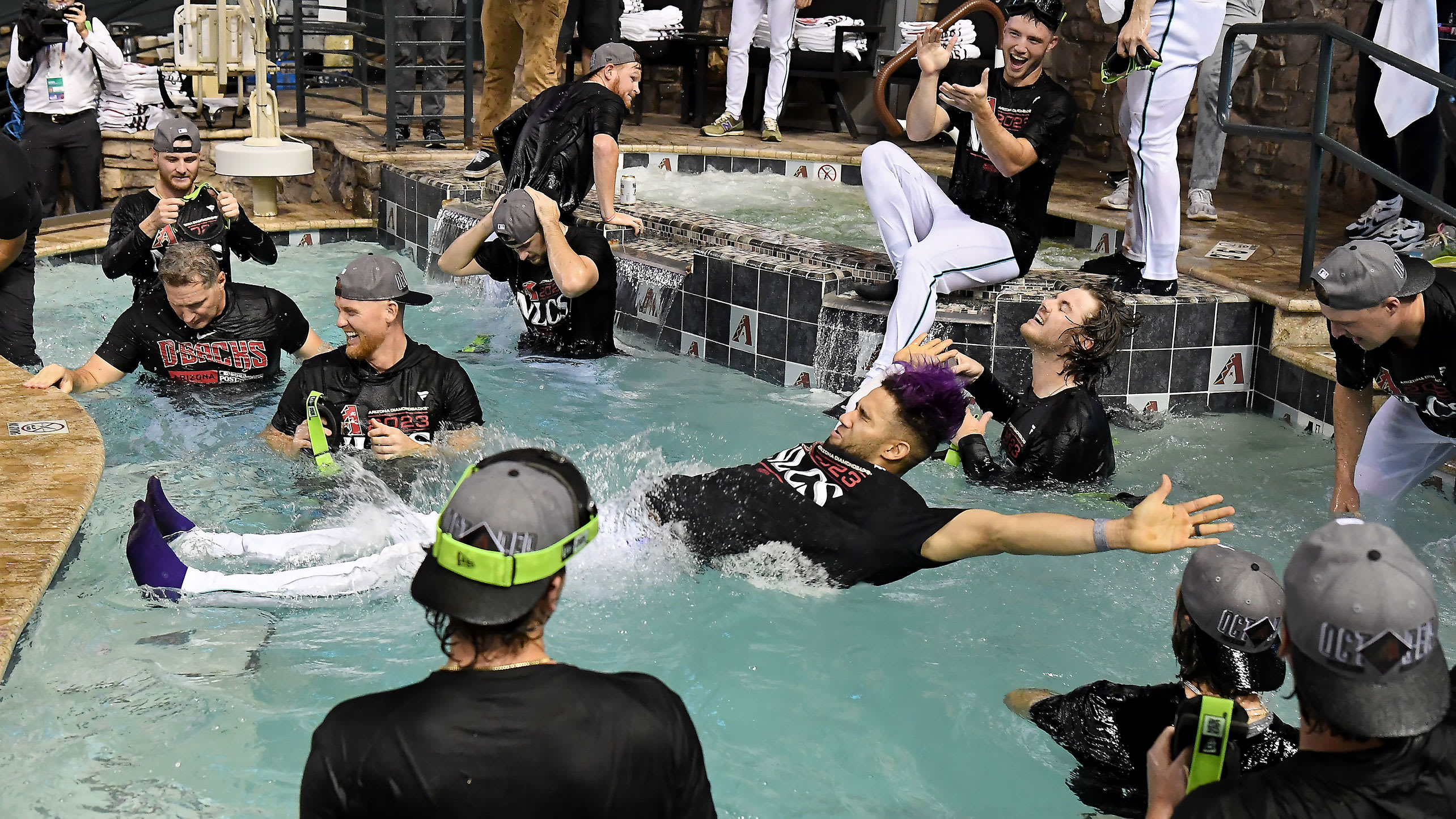Lourdes Gurriel Jr. falls backwards into the pool at Chase Field as the D-backs celebrate