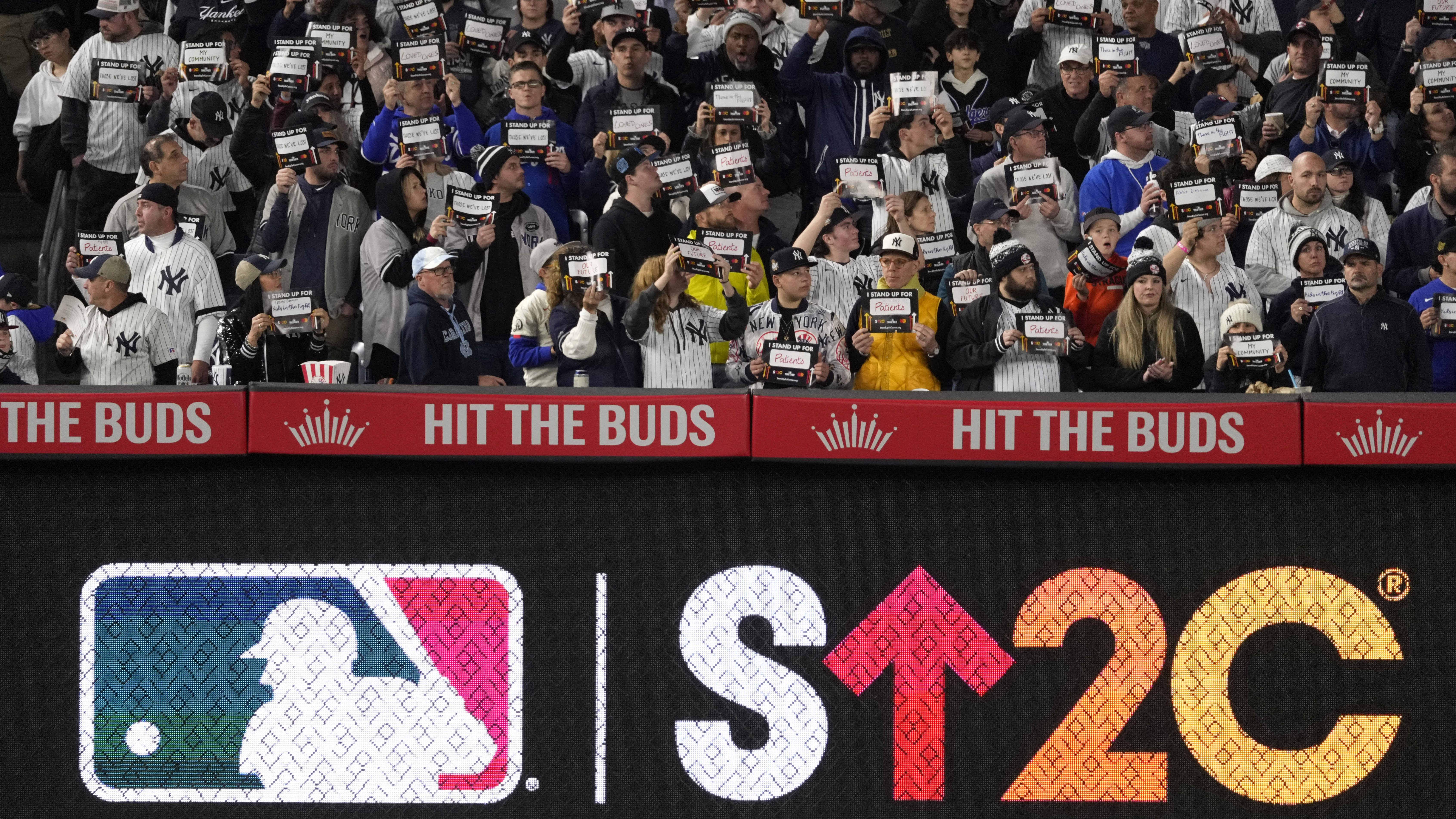 Fans hold up placards during the Stand Up To Cancer moment