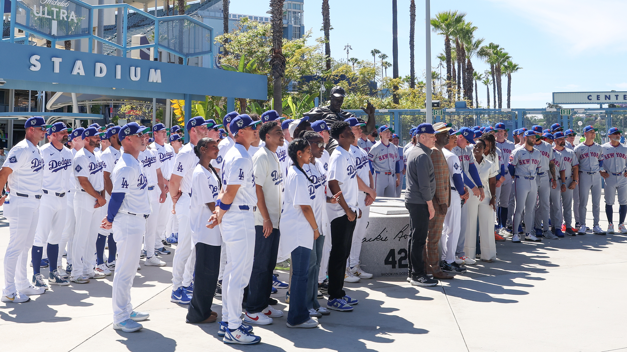 The Dodgers and Mets, in uniform, at Dodger Stadium's Jackie Robinson statue