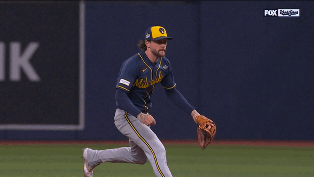 An animated gif of Brice Turang fielding a ground ball and throwing to first before breaking out in celebration