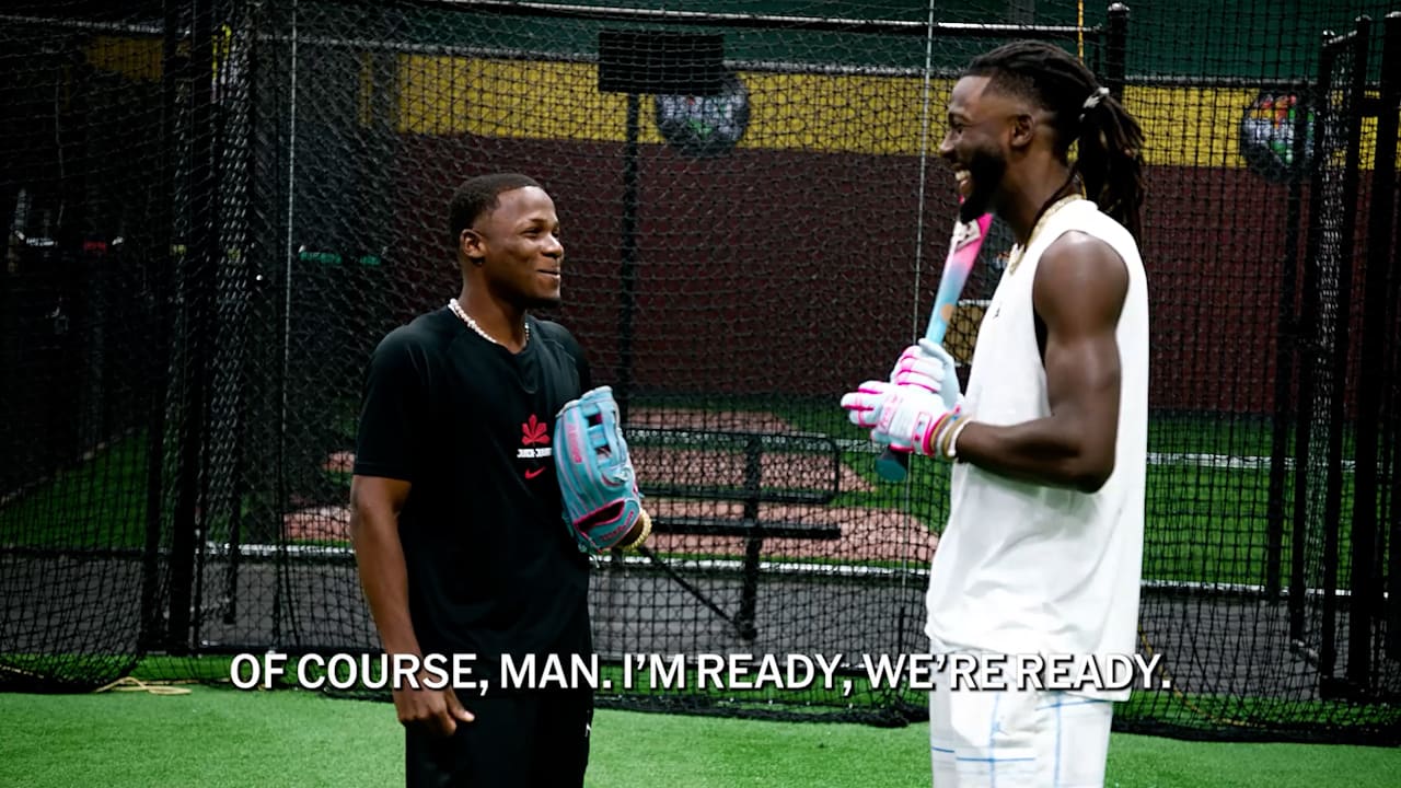 A screen shot of Pedro and Elly De La Cruz in a batting cage