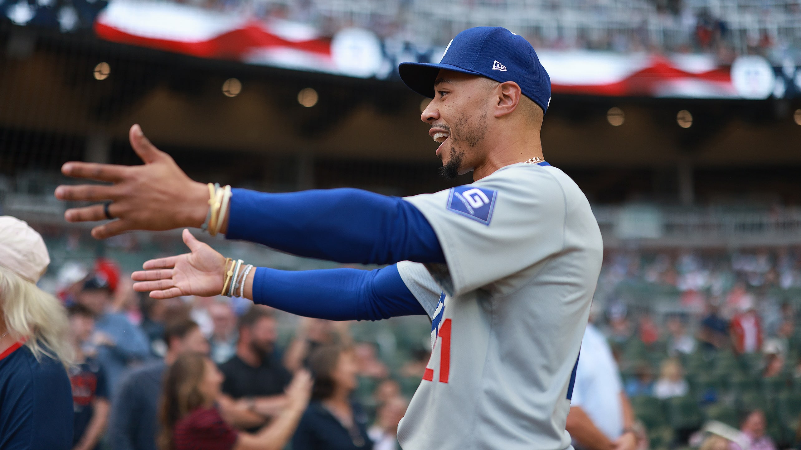 Mookie Betts reacts to someone by holding out his arms