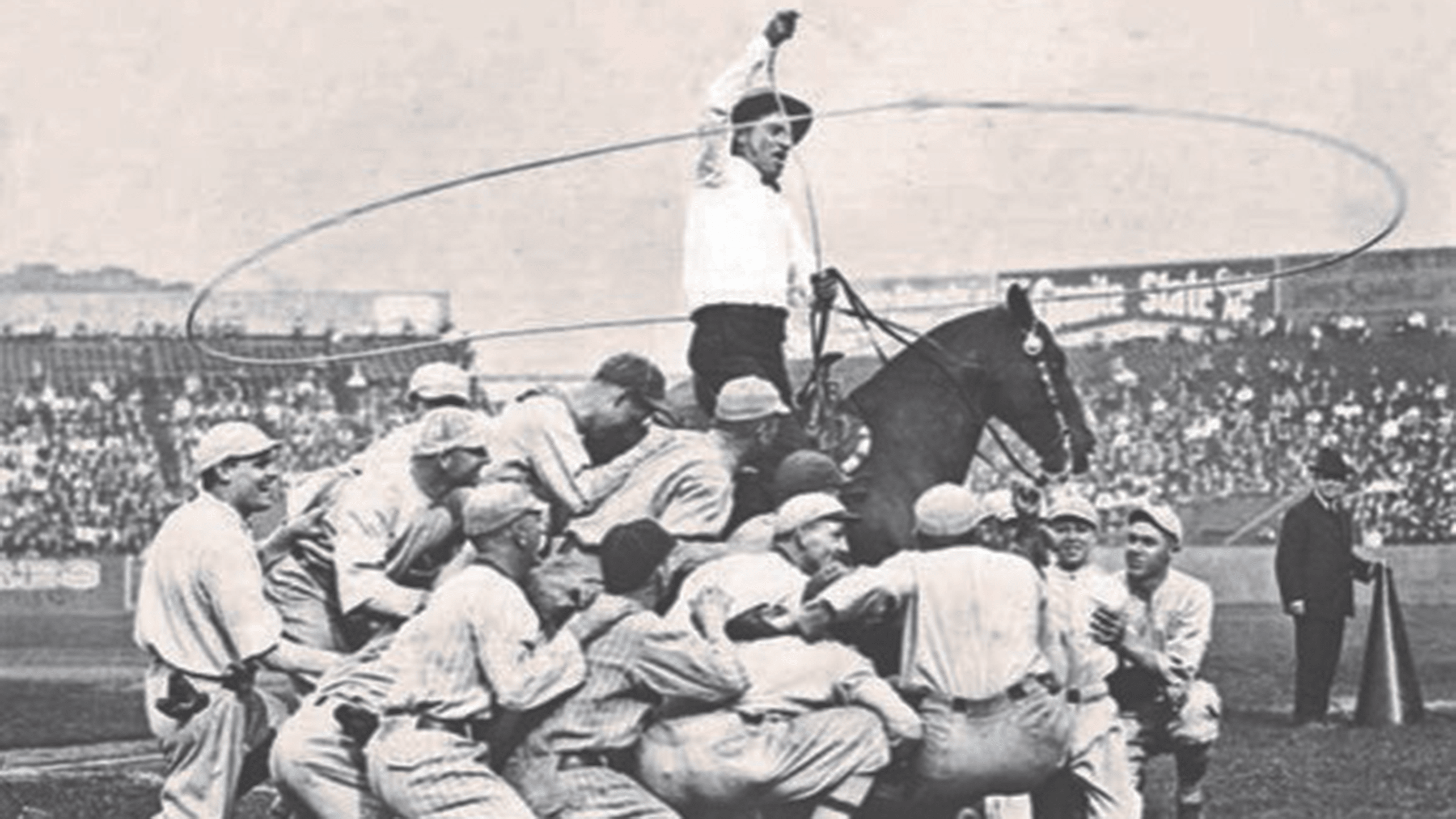 Entertainer Will Rogers on horseback about to lasso a group of ballplayers