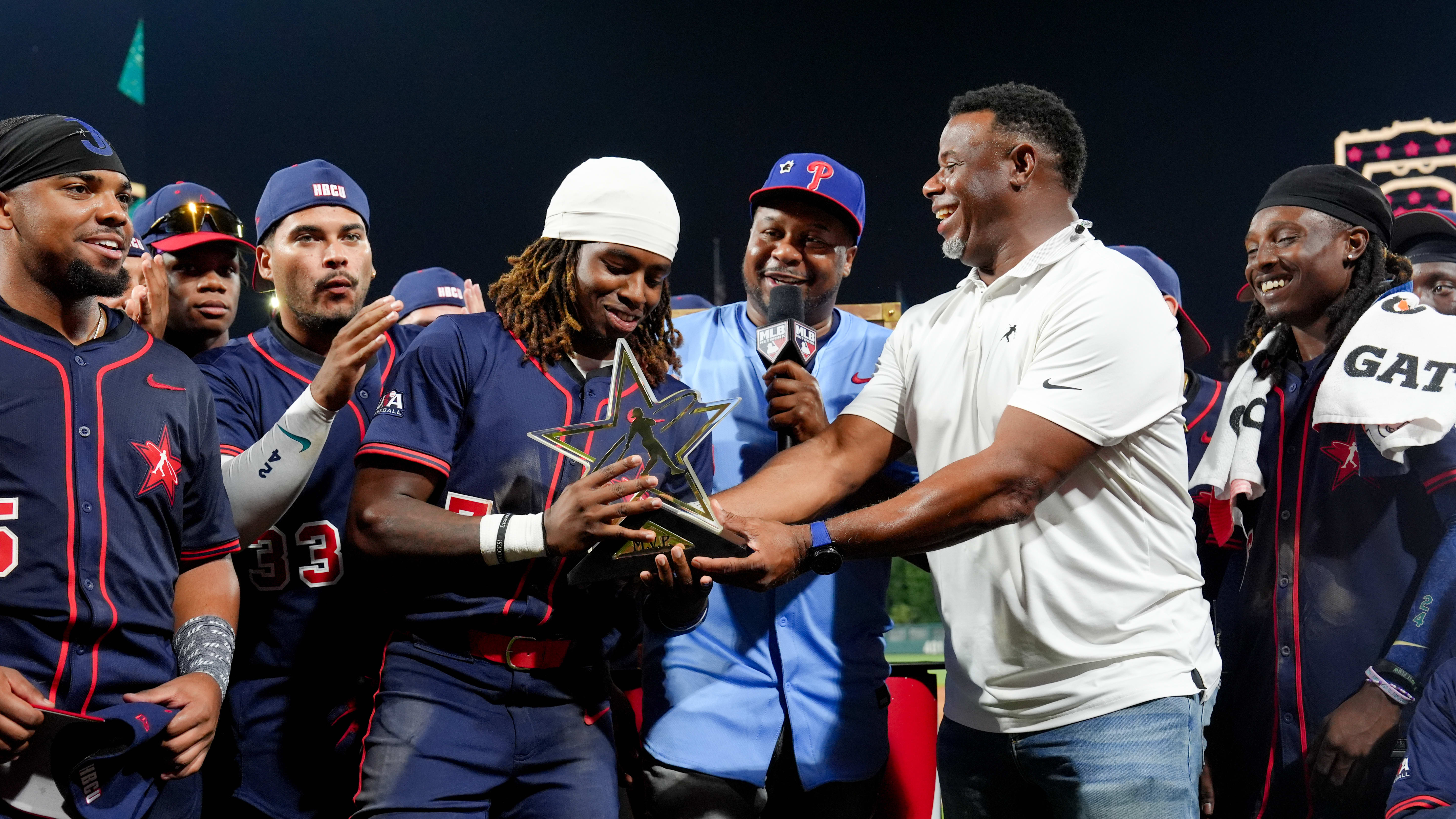 Ken Griffey Jr. presents the MVP trophy to Jacoby Radcliffe