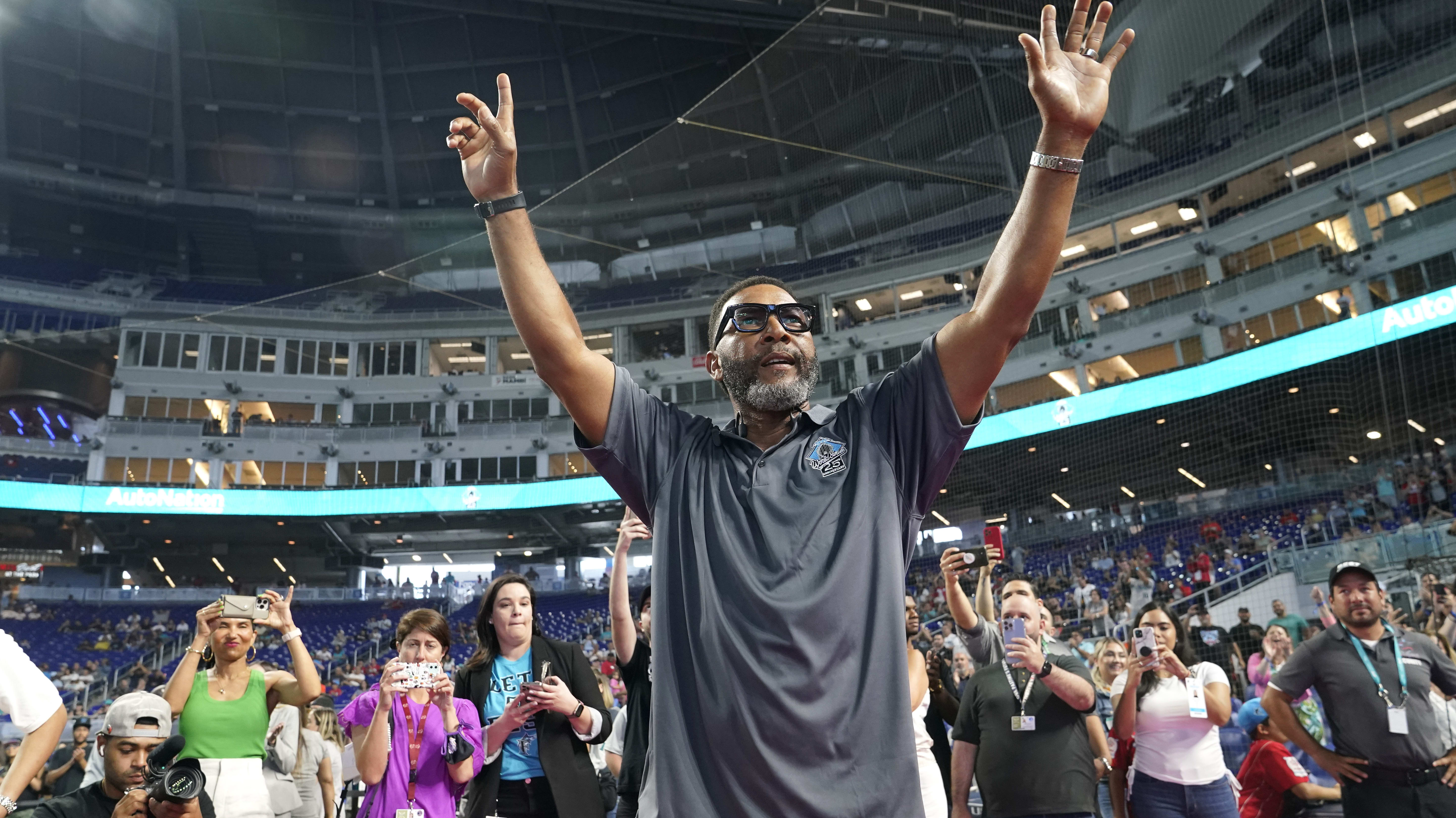 Gary Sheffield raises his arms to acknowledge fans