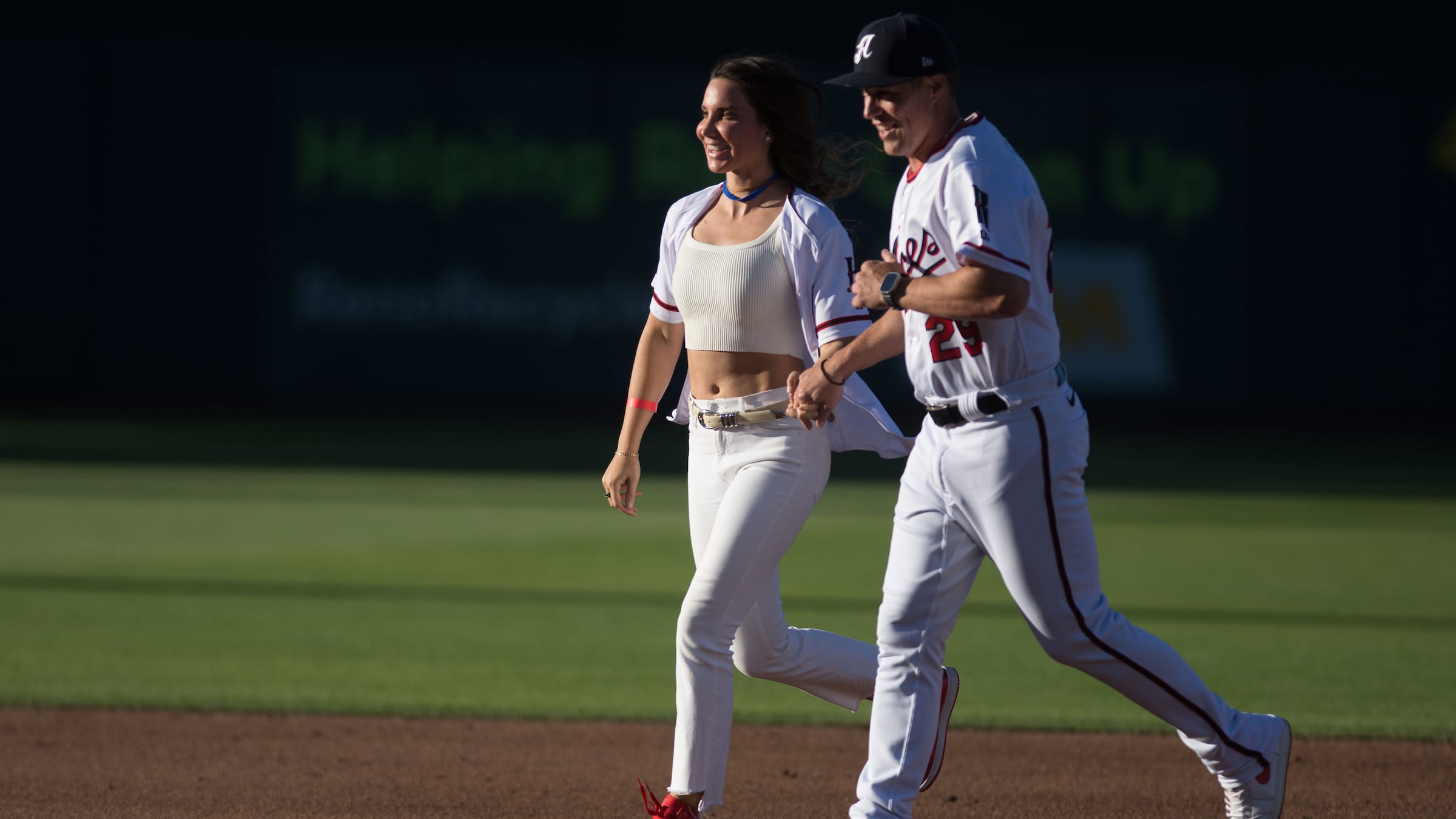 Triple-A Reno manager Blake Lalli and his girlfriend Aleah Hartung round the bases