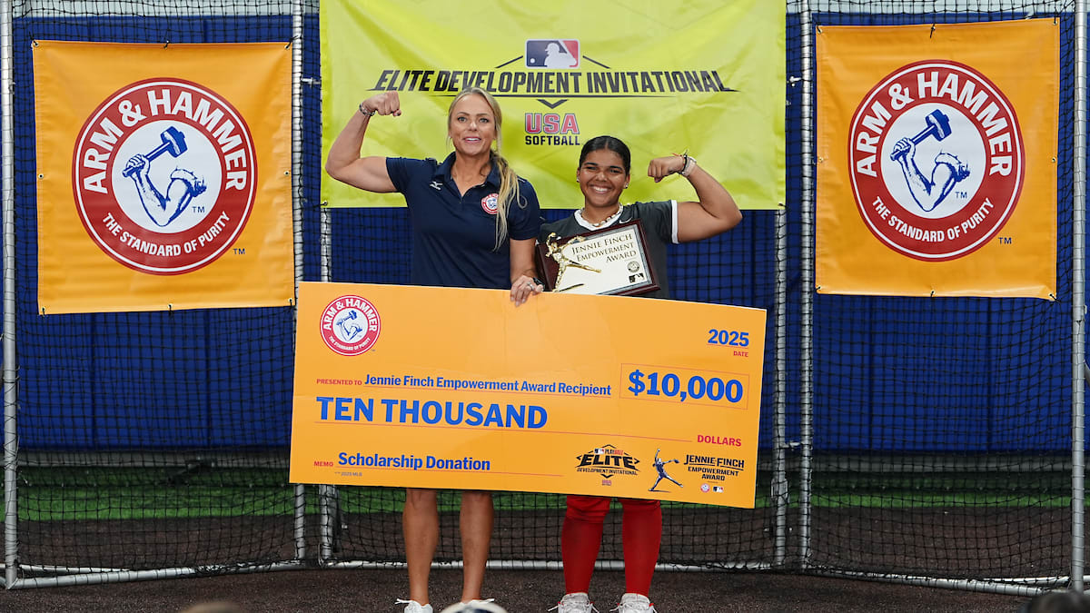 Jennie Finch and Marley Jackson flex their muscles while holding a large check