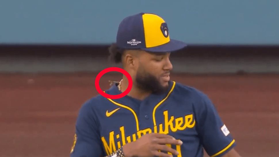 A praying mantis circled on Jackson Chourio's right shoulder