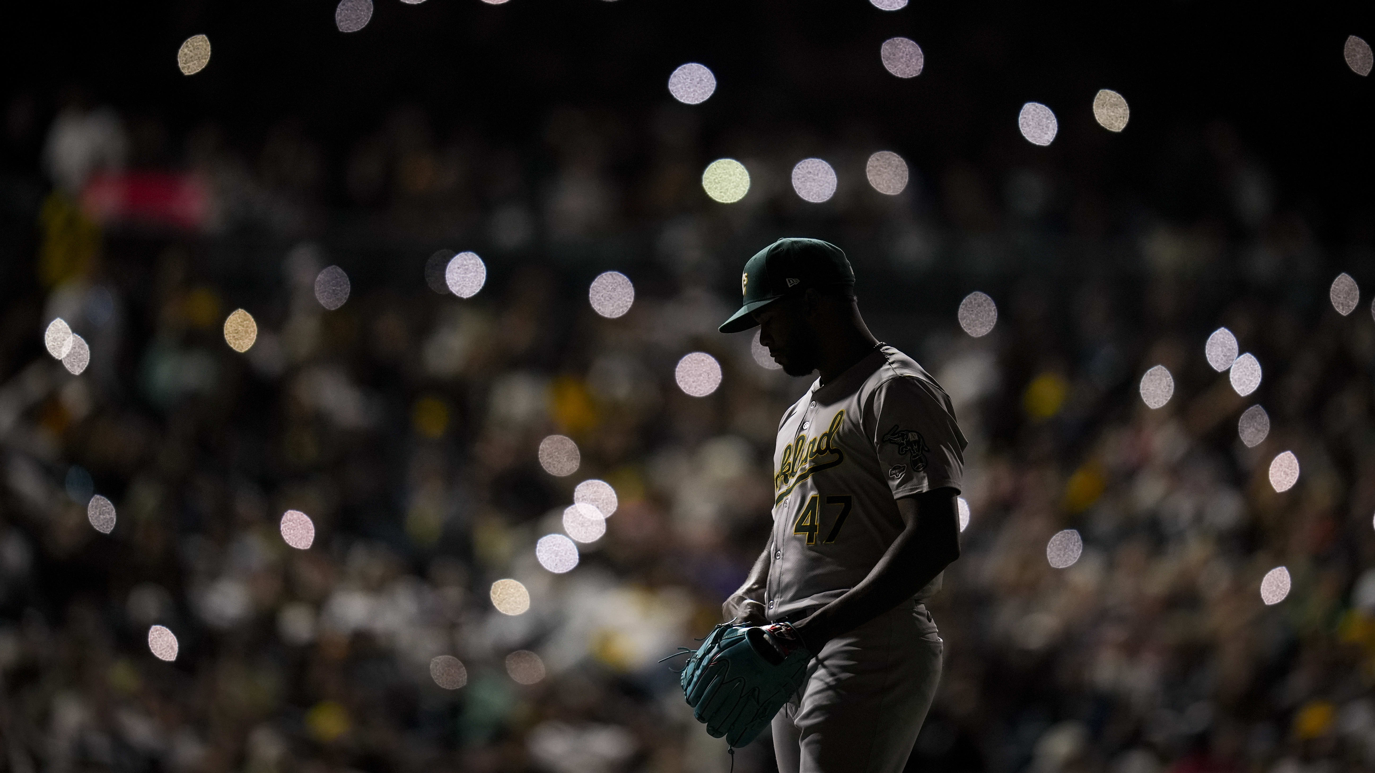 A's pitcher Michel Otañez in a darkened ballpark