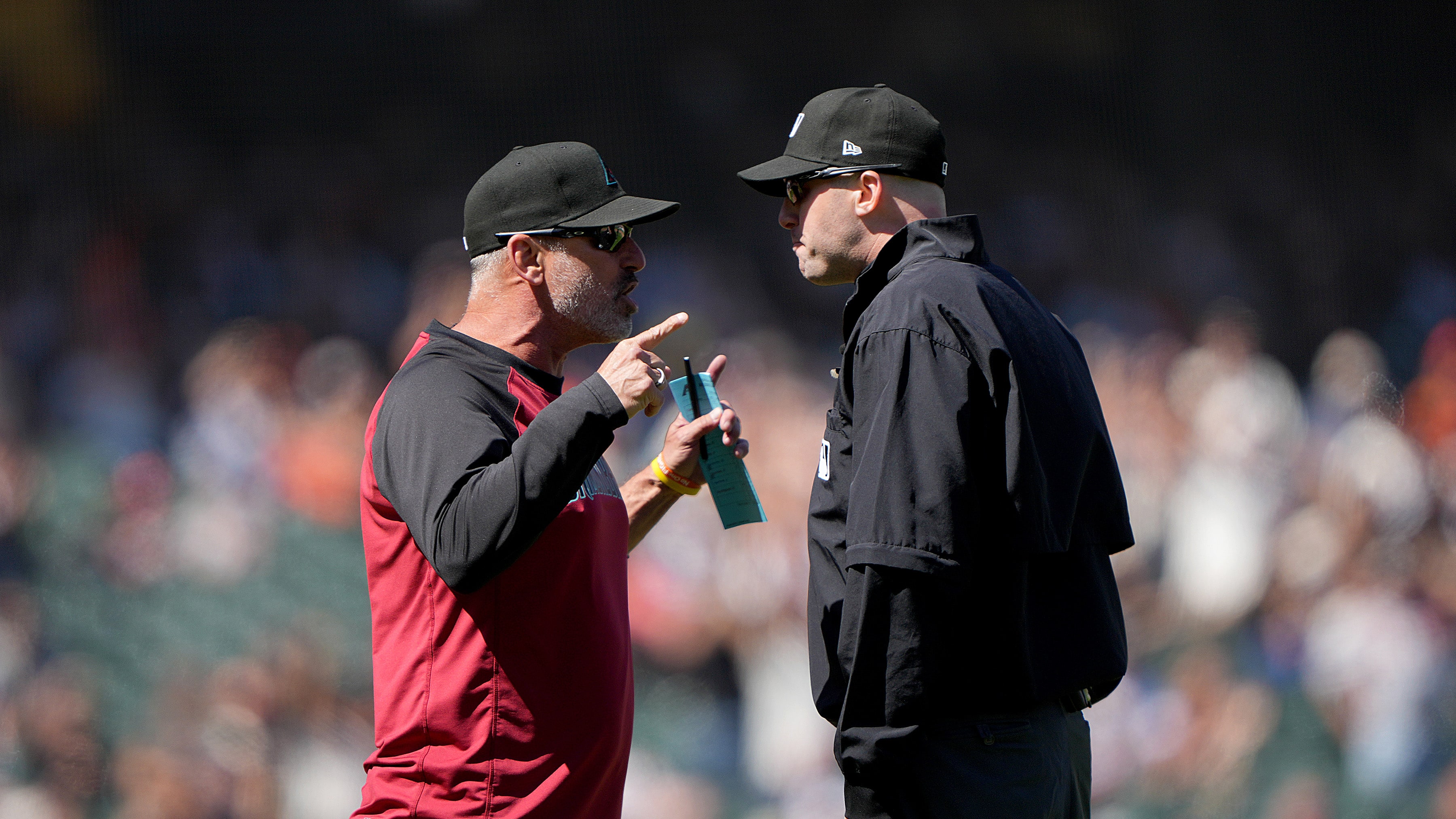 Arizona manager Torey Lovullo argues with umpire Mark Ripperger