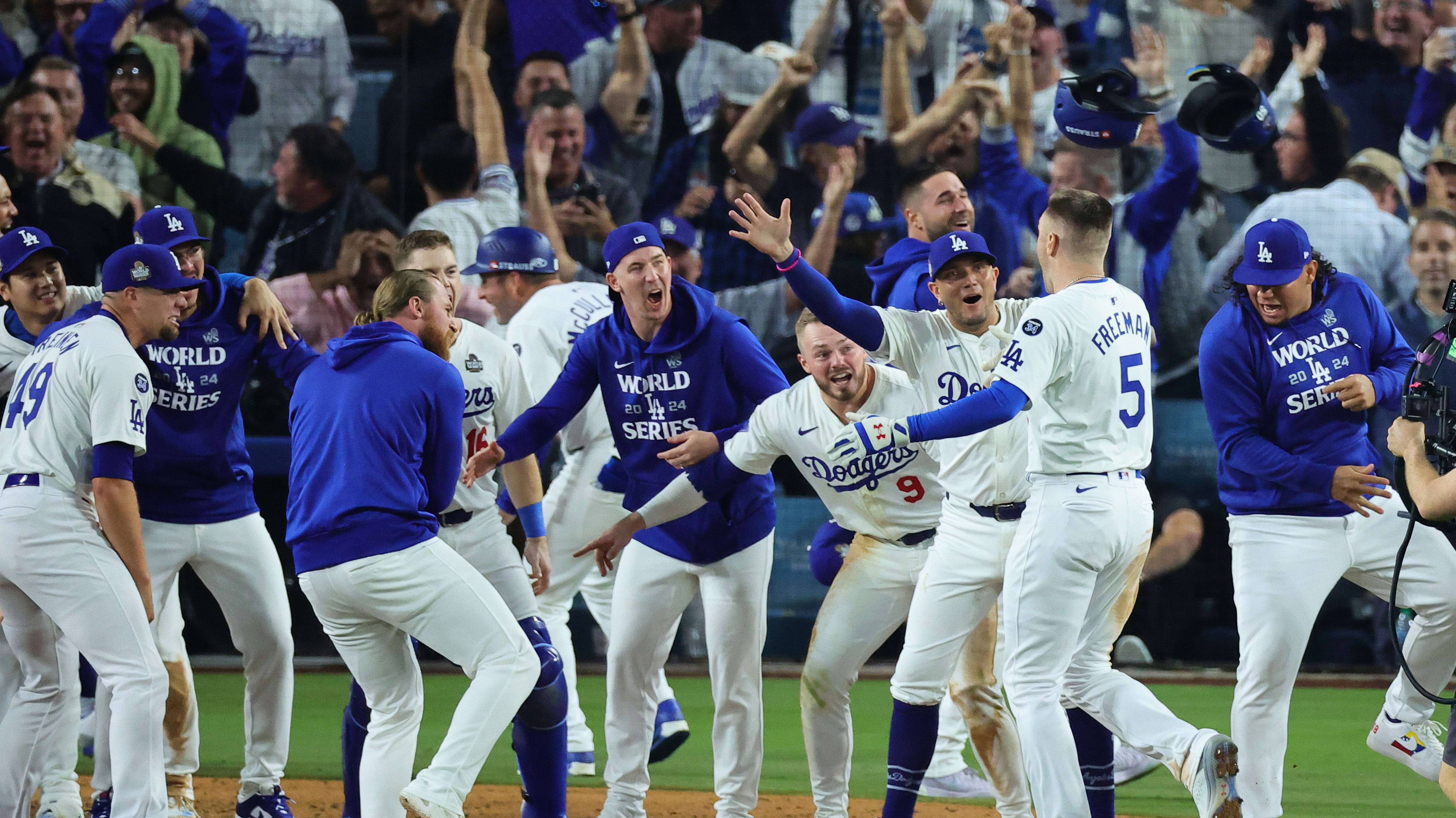 Freddie Freeman is greeted at the plate by the Dodgers after his walk-off grand slam in World Series Game 1