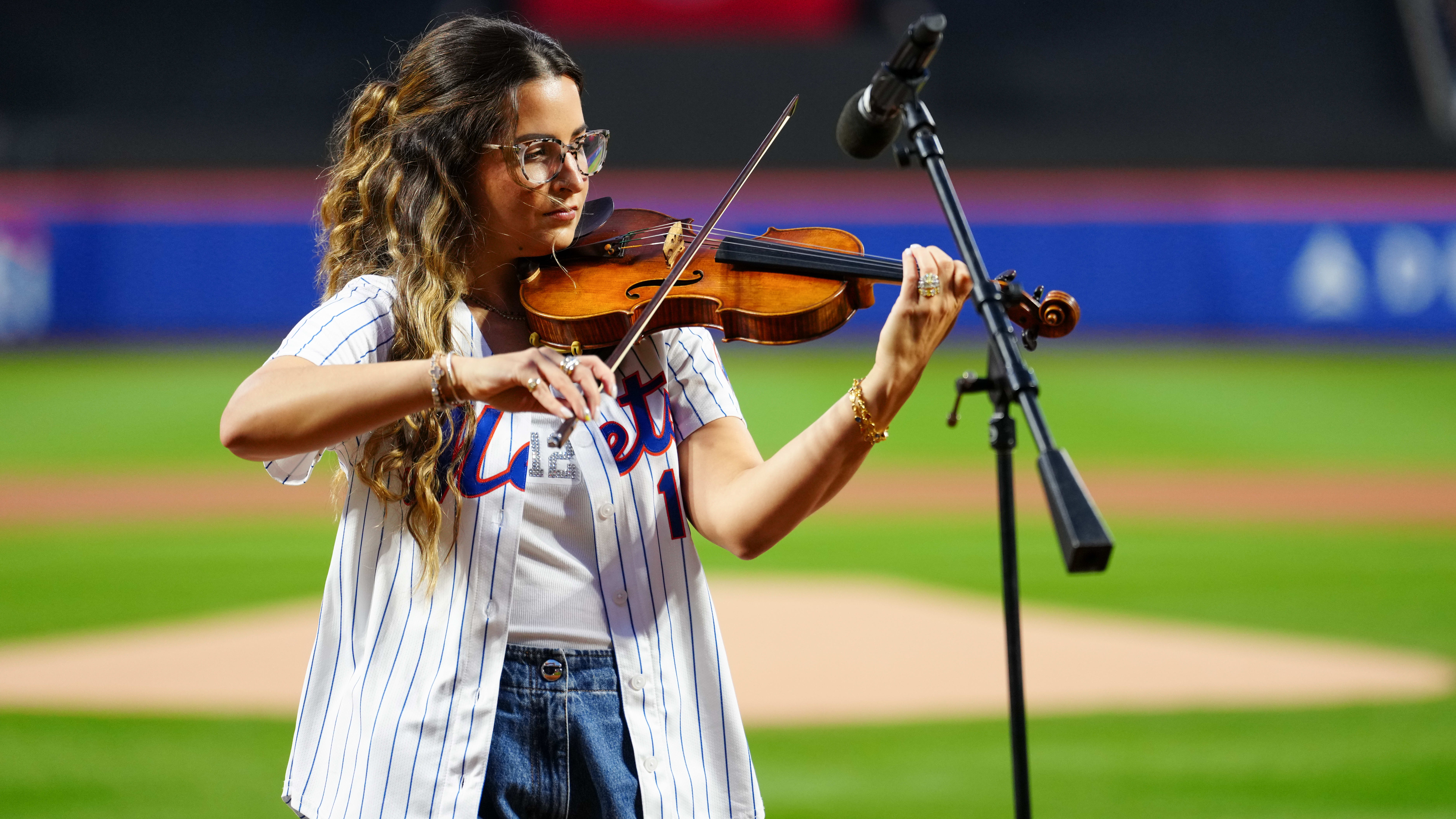 Katia Lindor plays the violin at Citi Field
