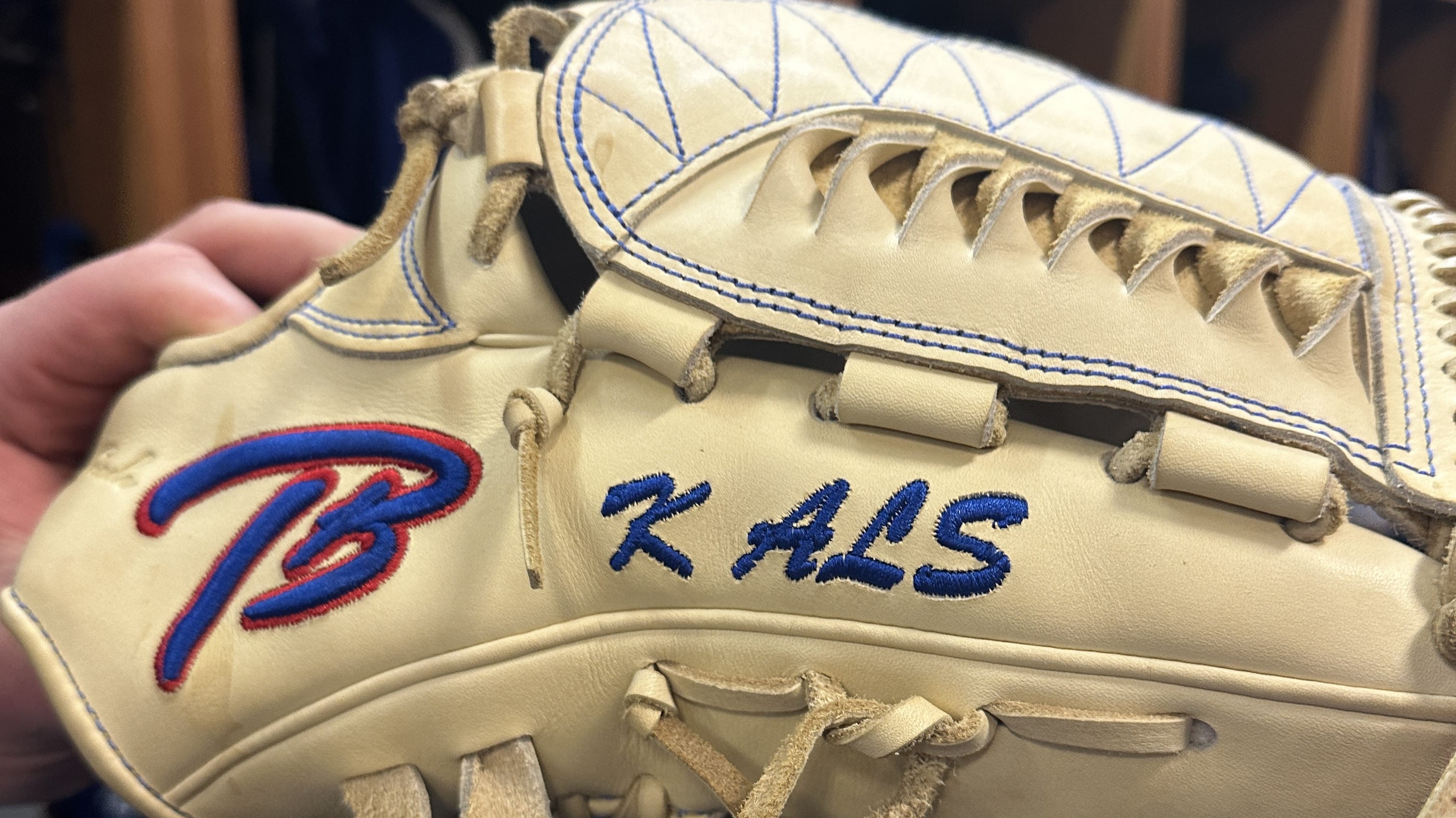 A glove with 'K ALS' stitched on it