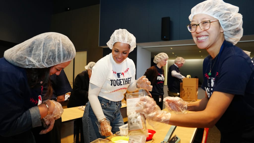 Employees participate during the MLB Together volunteer event co-hosted by Rise Against Hunger.