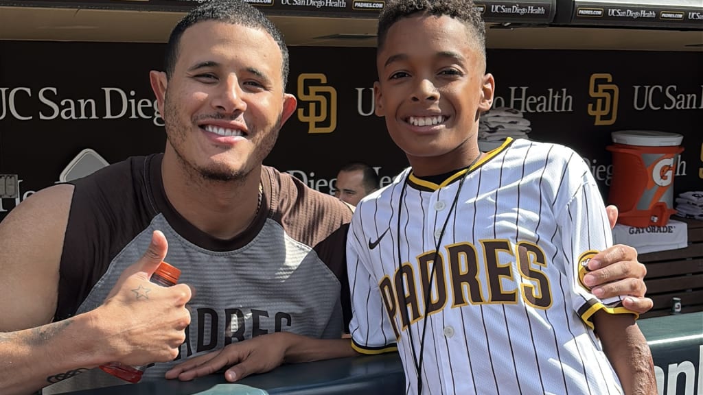 Manny Machado and Mikey Martinez in the Padres' dugout.