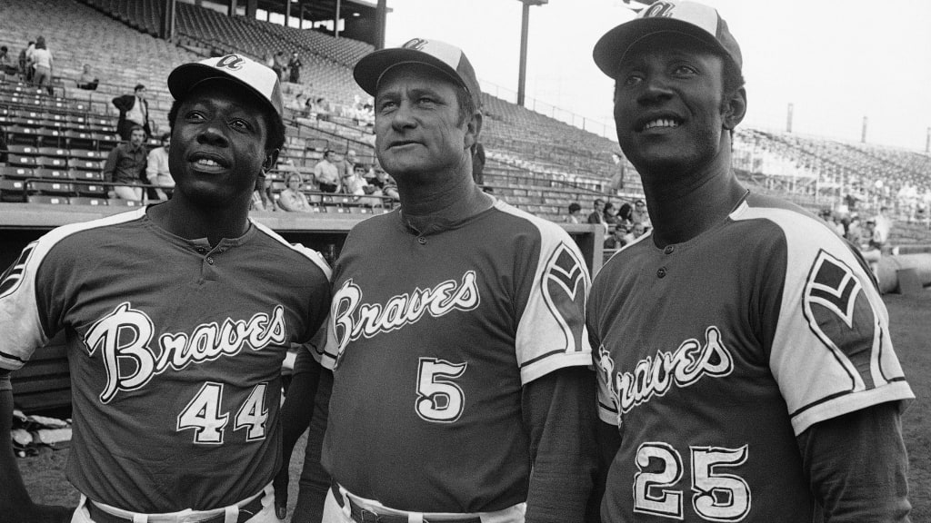 Hank Aaron (44), Lew Burdette (5) and Rico Carty (25) look up into stands at night on May 22, 1972, before an exhibition game against the Brewers in Milwaukee. (AP)