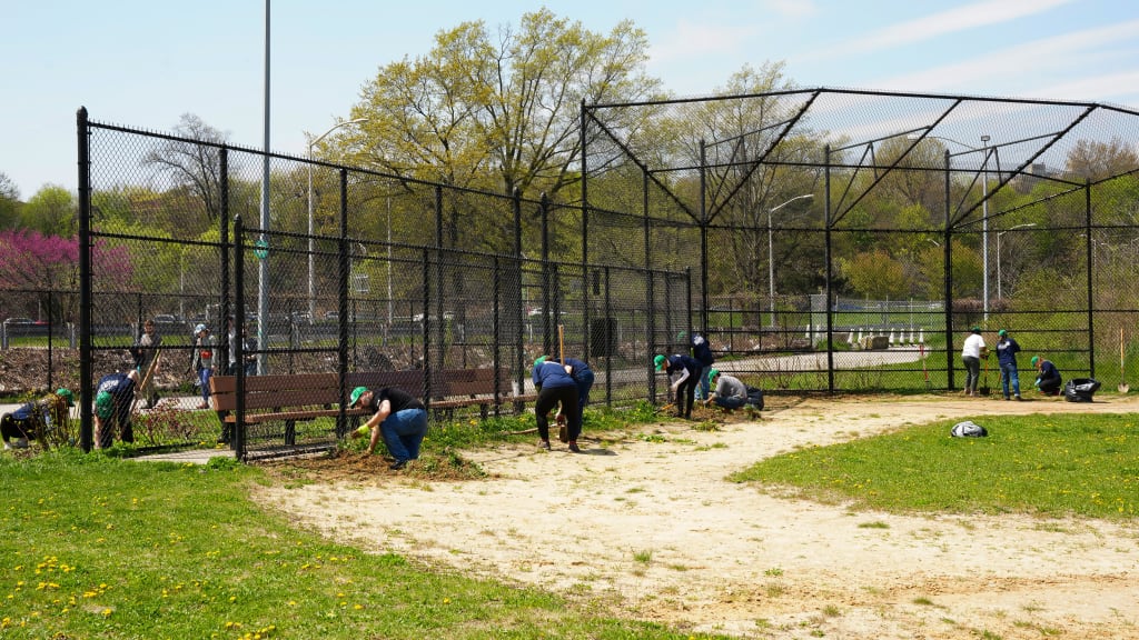 Volunteers spread clay on the infield and weeded gardens at Corona Park. (Photo by Mary DeCicco/MLB Photos)